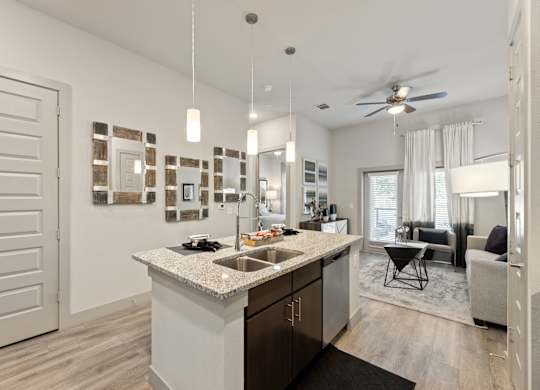 A modern kitchen with a large island and a dining area.