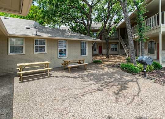 A small house with a porch and a picnic table.