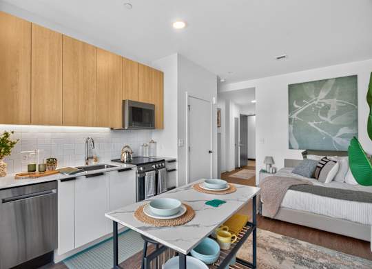 A modern kitchen with a dining table set for two at The Indie in Allston.