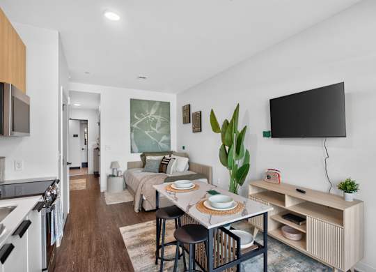 A modern kitchen with a dining table set for two at The Indie in Allston.