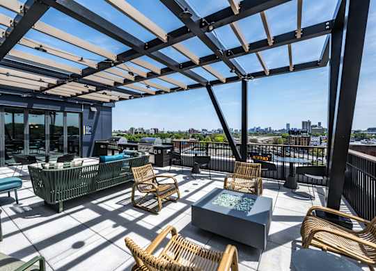 A patio with a table and chairs under a roof.