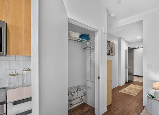 A white hallway with a rug and a lamp on the right.