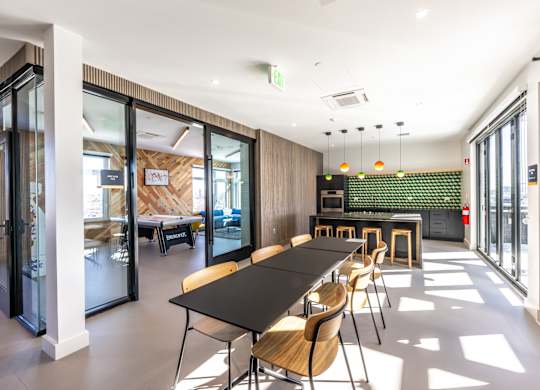 A conference room with a long table and chairs.