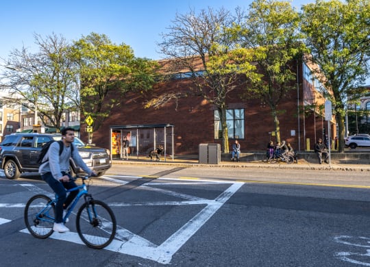 a man riding a bike in a crosswalk on a city street