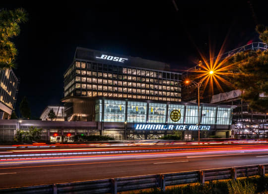Bose sign lit up at night at Boston Landing, Allston MA