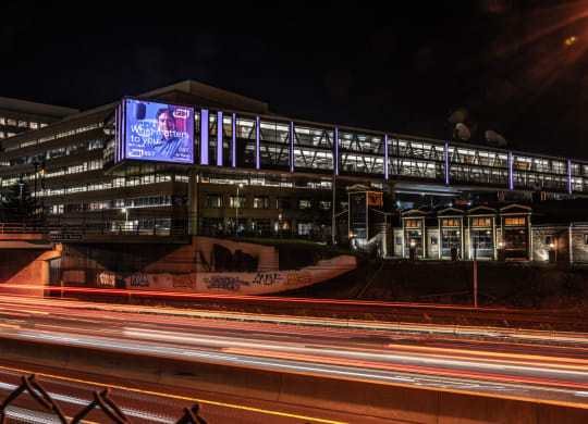 Corner of WGBH billboard lit up at night