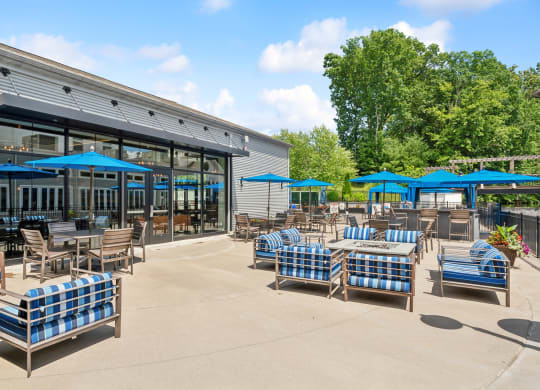 an outdoor patio with blue and white chairs and tables at The Tannery, Connecticut, 06033