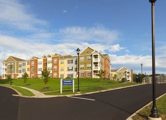 A street view of apartment buildings with a sign that says Tannen.