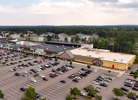 A parking lot with a large building in the background.