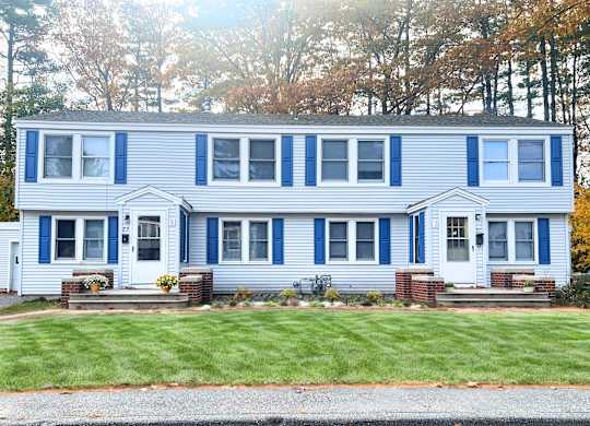 A blue and white house with a grey roof.