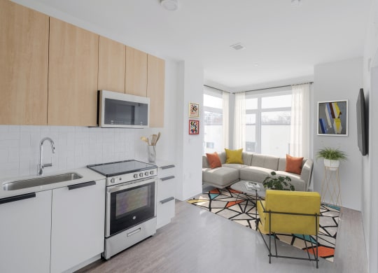 a living room with a kitchen and a couch and a table