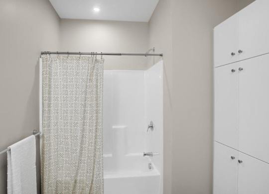 a bathroom with a shower and a shower curtain