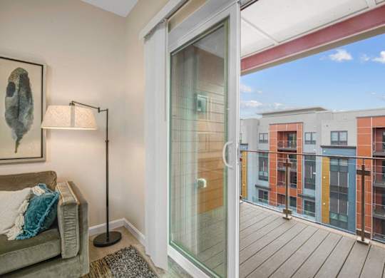 a balcony with a couch and a glass door