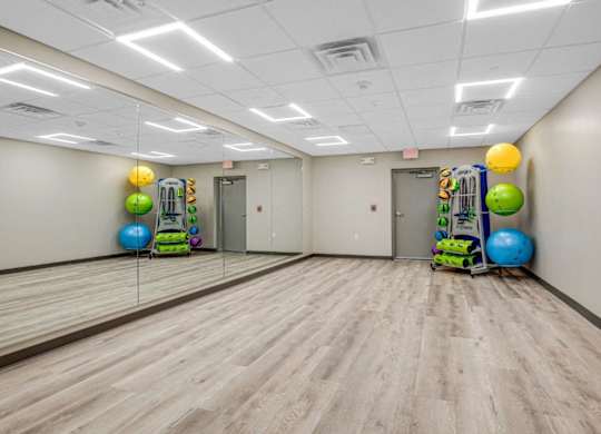a large room with a dance floor and balls and mirrors