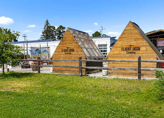 A wooden building with a sign that says Flight Deck.