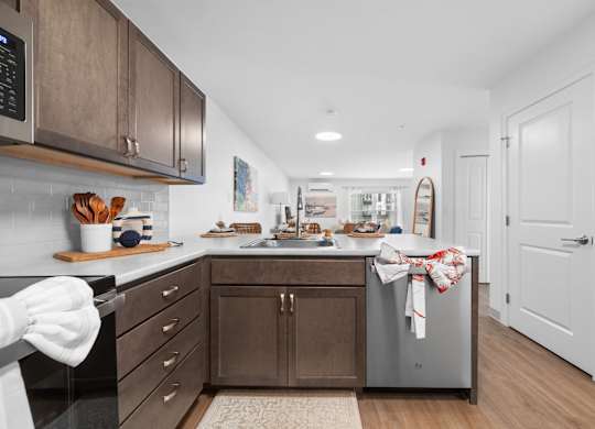 A kitchen with wooden cabinets and a black countertop.