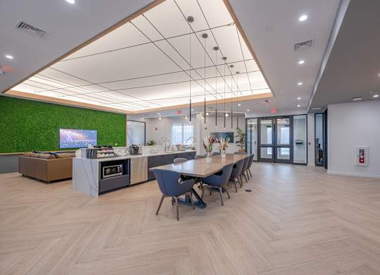 A modern office space with a long table and chairs at Seacoast Residences Apartments, Oakland, ME