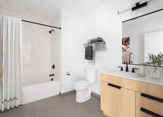 A white toilet sits next to a sink in a bathroom.
