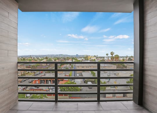 a balcony with a view of the city at The Fairfax Flats Apartments, Los Angeles, CA