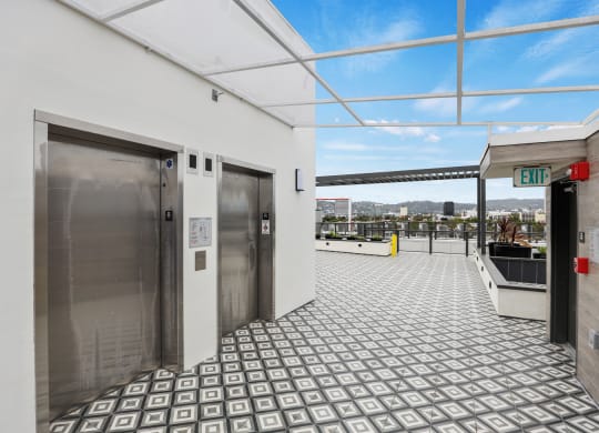 a view of the elevators on the top floor of the building at The Fairfax Flats Apartments, Los Angeles, CA