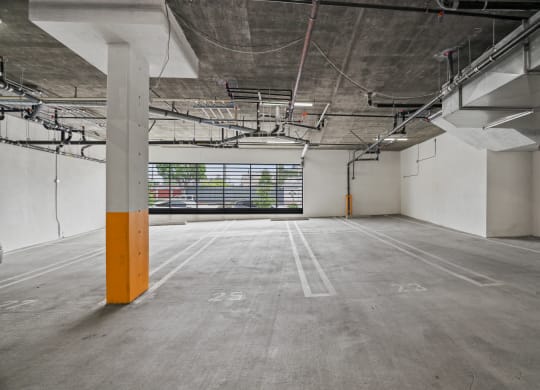 an empty parking lot with a large window in the background at The Fairfax Flats Apartments, California