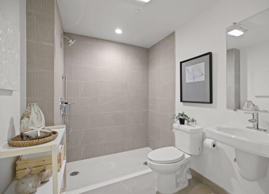 a bathroom with a sink toilet and bathtub at The Fairfax Flats Apartments, California, 90019
