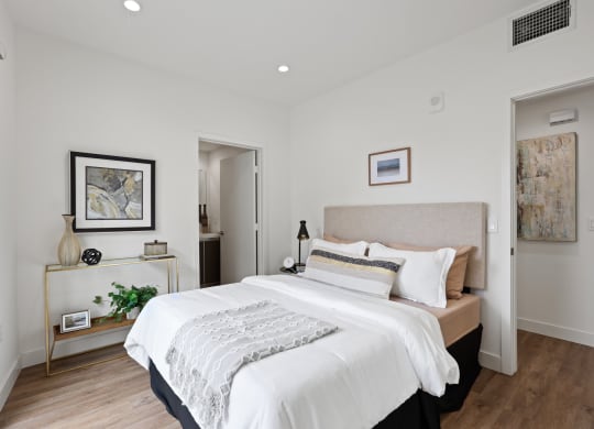 a bedroom with a large bed in a room at The Fairfax Flats Apartments, California