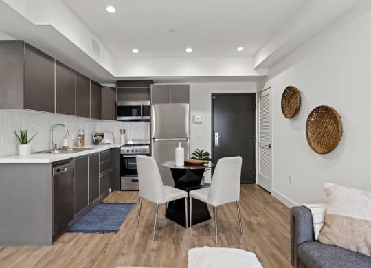a kitchen and dining area in a 555 waverly unit at The Fairfax Flats Apartments, California