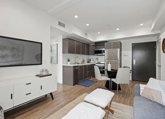 a living room with white walls and hardwood floors at The Fairfax Flats Apartments, Los Angeles, CA