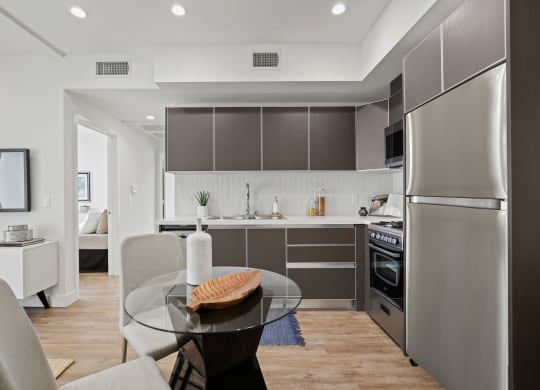 a kitchen and dining area in a 555 waverly unit at The Fairfax Flats Apartments, Los Angeles, CA