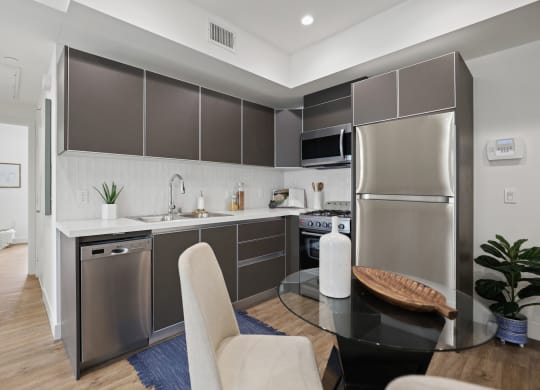 a kitchen and dining area in a 555 waverly unit at The Fairfax Flats Apartments, California, 90019