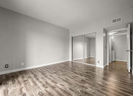A room with wooden flooring and a sliding door at Lafayette Apartments, California