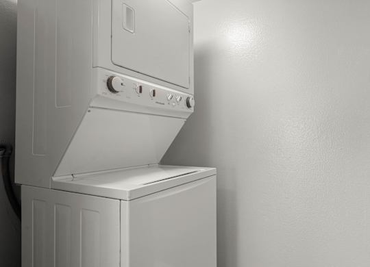 A white oven with a hood is mounted on a wall at Lafayette Apartments, Los Angeles, California