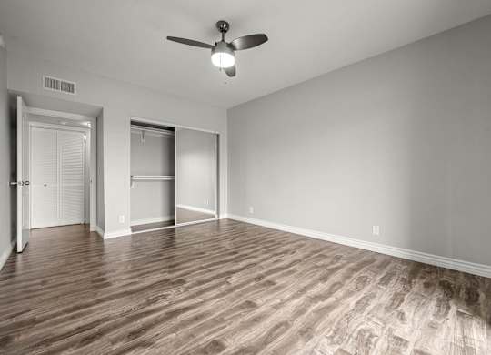A room with a ceiling fan and wood flooring at Lafayette Apartments, Los Angeles 90019