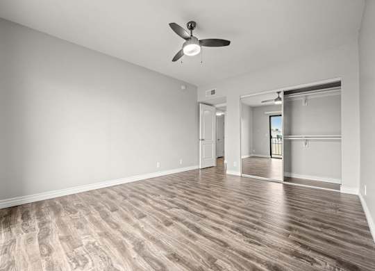 A room with a ceiling fan and wooden flooring at Lafayette Apartments, California, 90019