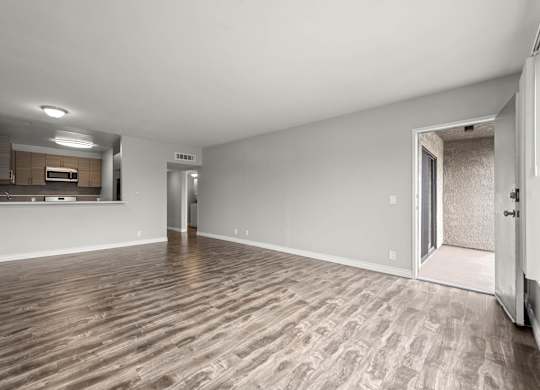 A room with wooden flooring and white walls at Lafayette Apartments, Los Angeles