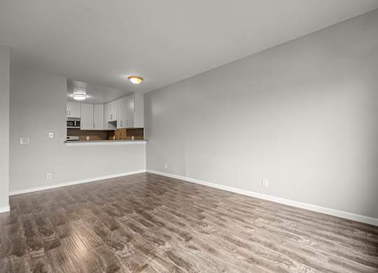 A room with a wooden floor and white walls at Lafayette Apartments, Los Angeles, California