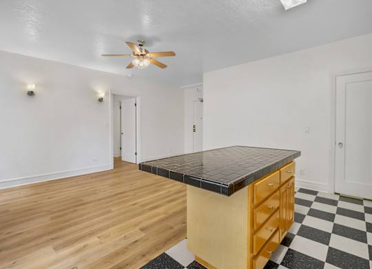 Kitchen with ceiling fan at The Langham Apartments, California, 90005