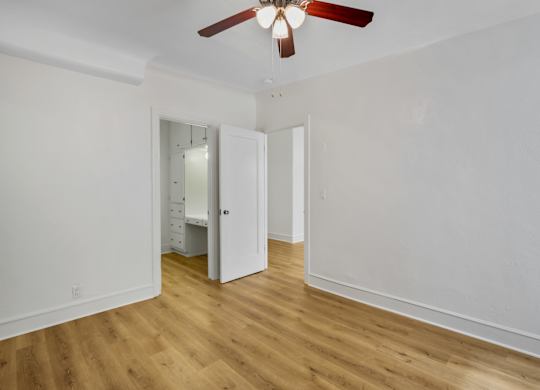 Spacious bedroom with ceiling fan at The Langham Apartments, Los Angeles, California