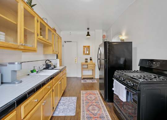 Kitchen with modern appliances at The Langham Apartments, California