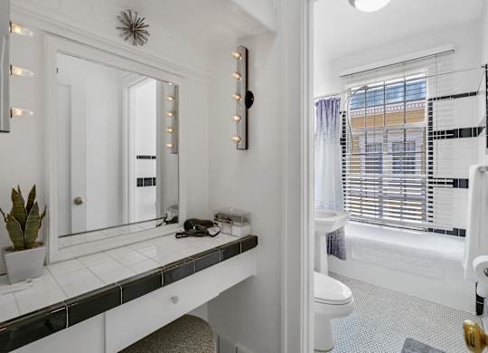 Bathroom with mirror at The Langham Apartments, California, 90005