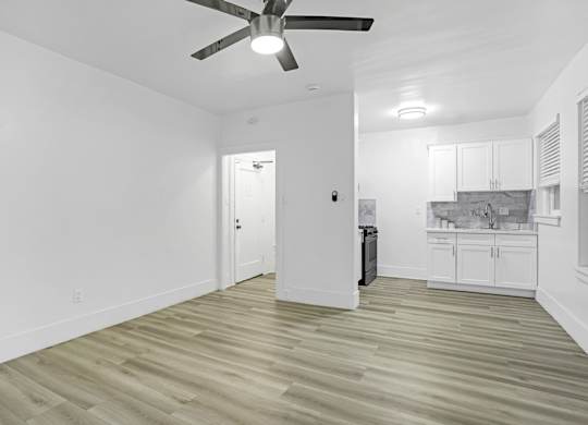 A room with a ceiling fan and lighting fixture.at Park Wilshire, California