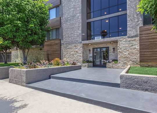 A modern building with a stone facade and a glass entrance at Lafayette Apartments, California