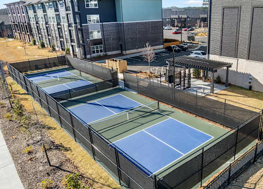 Tennis courts surrounded by a fence.