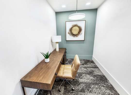 A room with a wooden table and a chair.