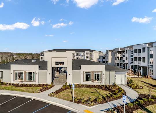A building with a parking lot in front of it.