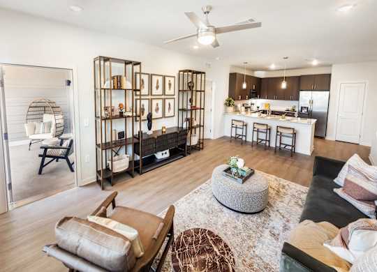 A modern living room with a black leather couch and a wooden coffee table.