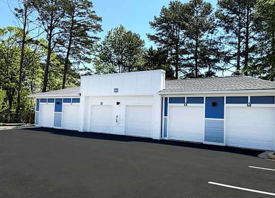 A large white building with blue trim and a grey roof.