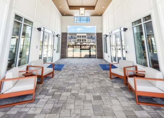 A long hallway with a wooden ceiling and tiled floor.