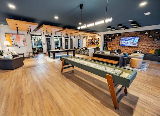 A room with a pool table and a bar.